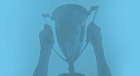 man holding a trophy in the air
