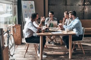 five-people-around-table-working-modern-office-