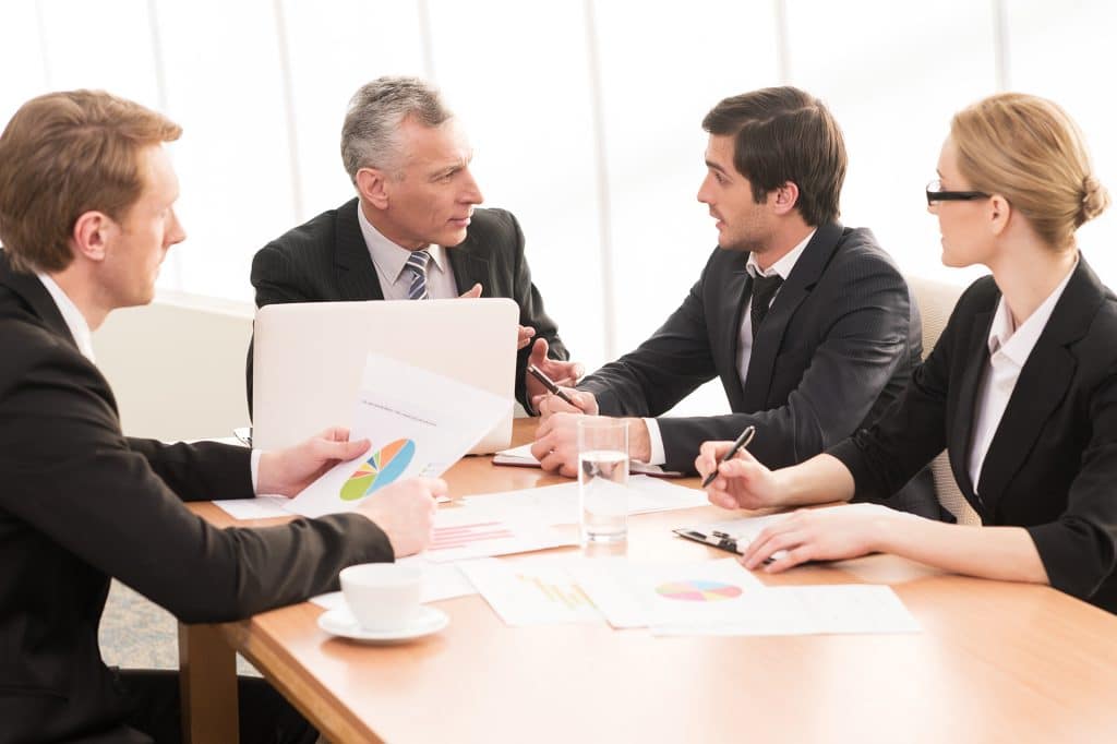 business-meeting-three-men-one woman-data-analysis