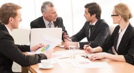 business-meeting-three-men-one woman-data-analysis