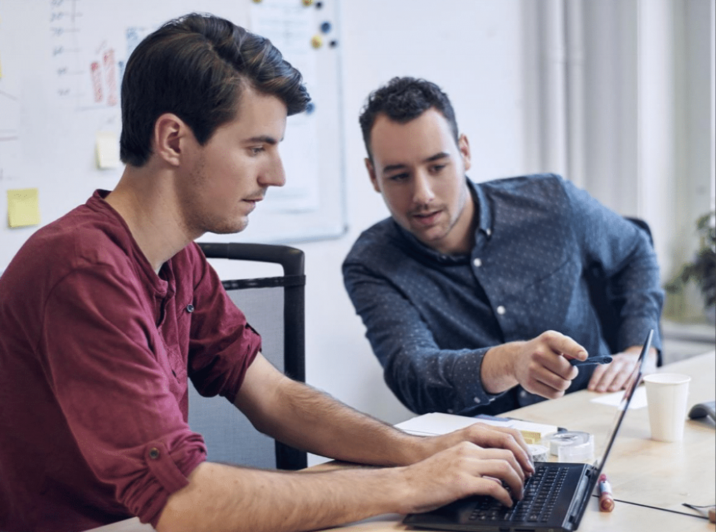 two men looking at a screen
