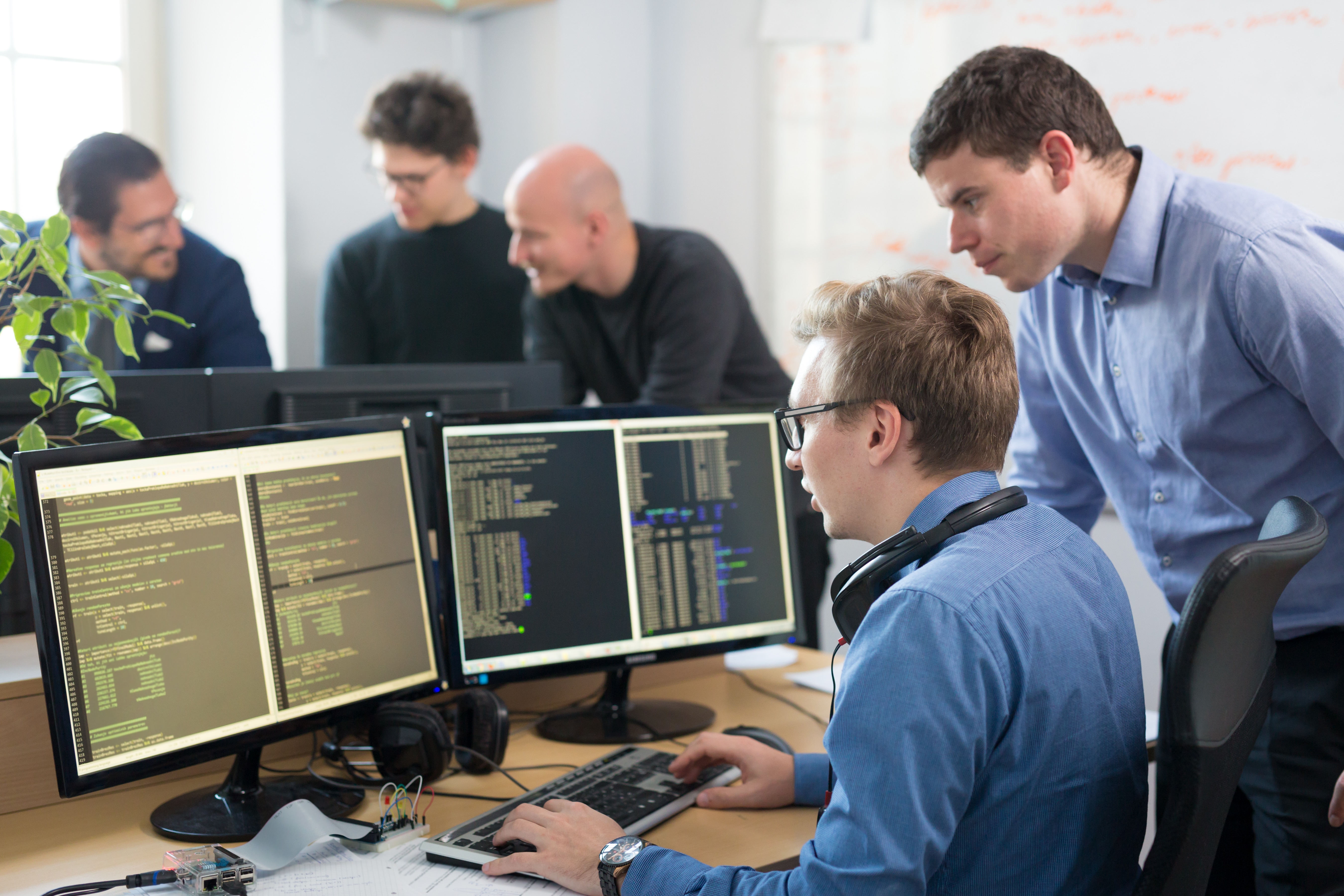 professional man showing another man data on screens