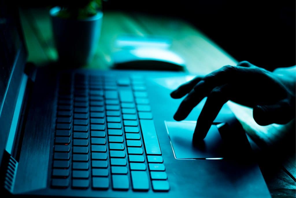 Social Engineerting Person typing on a keyboard 