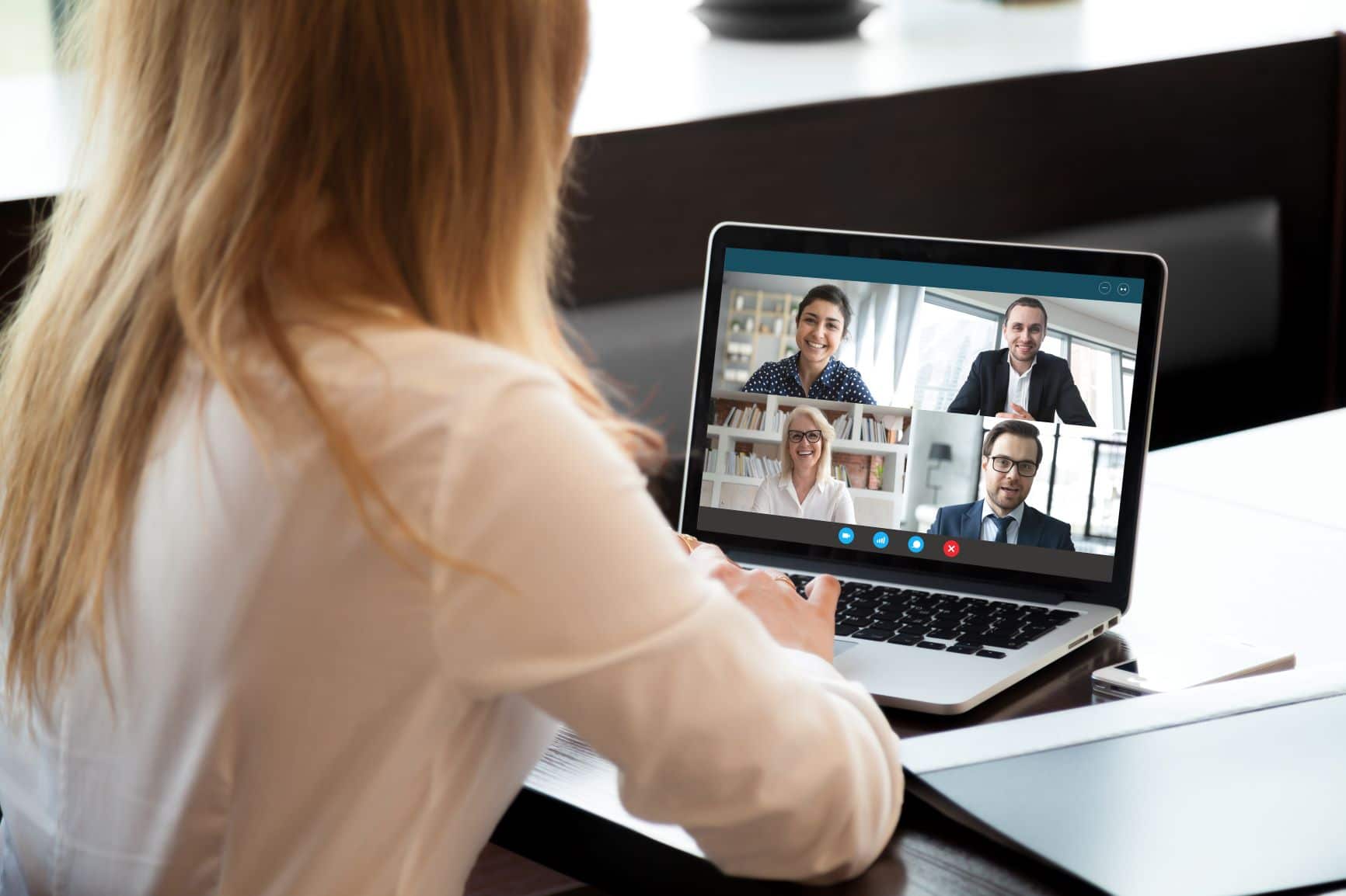 woman on zoom call with other hybrid workers
