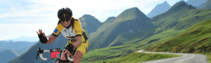 image of anjela cycling in front of mountains on a winding road women in tech 