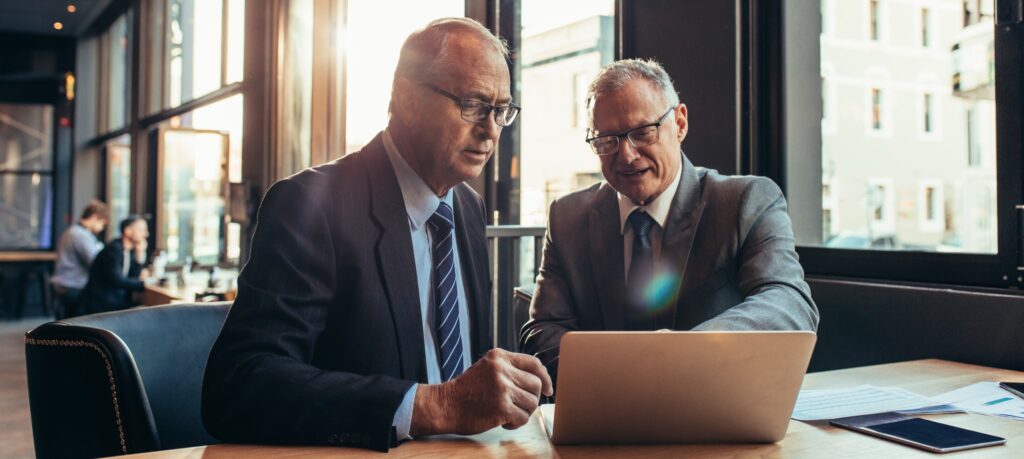 Two business men working out how to save money on third-party Oracle support from IBM with Northoor